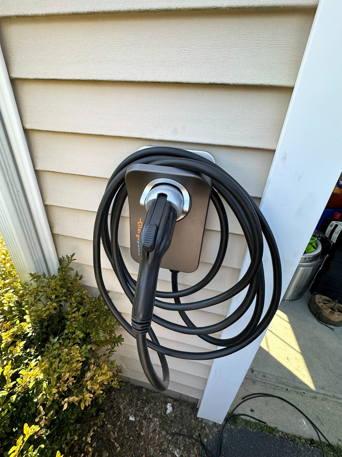 Home EV charger installed on the side of a Massachusetts house