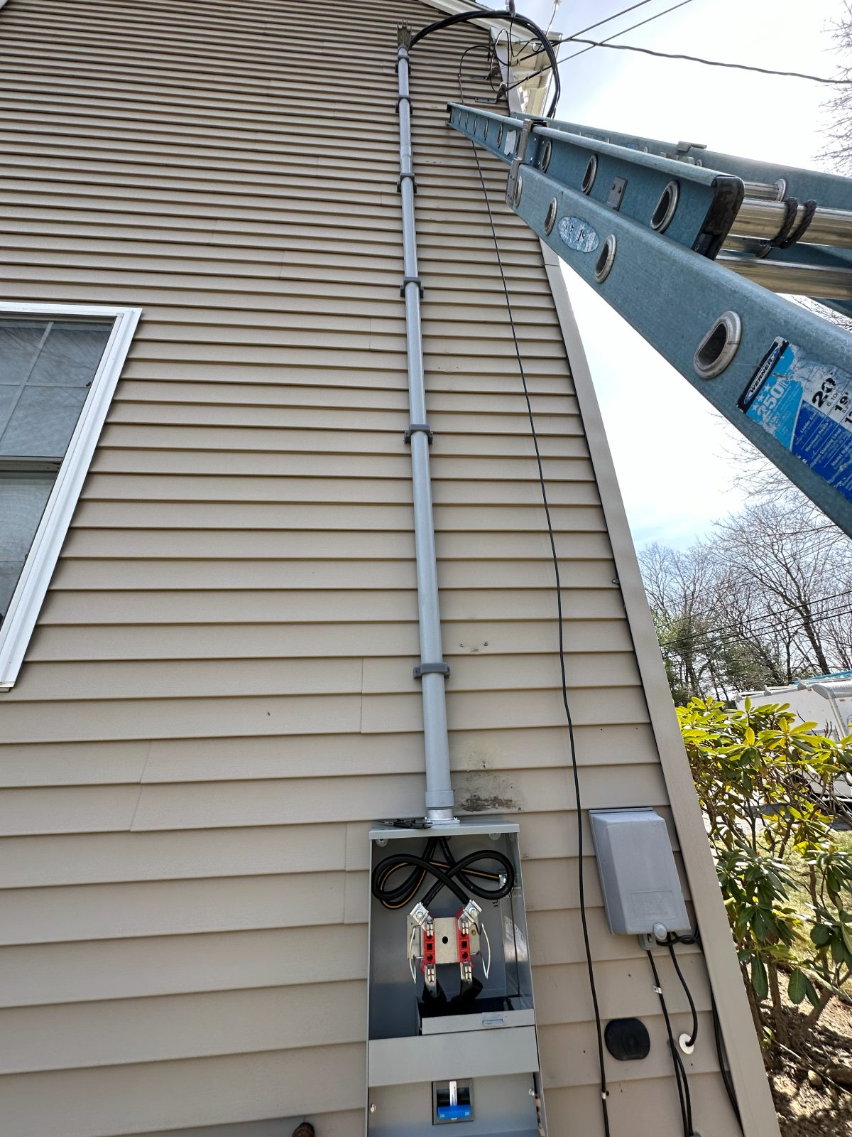 New service mast and meter on a house